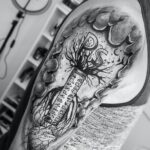 grayscale photo of skull tattoo